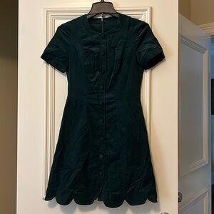 Gal meets glam green courdory scalloped dress.